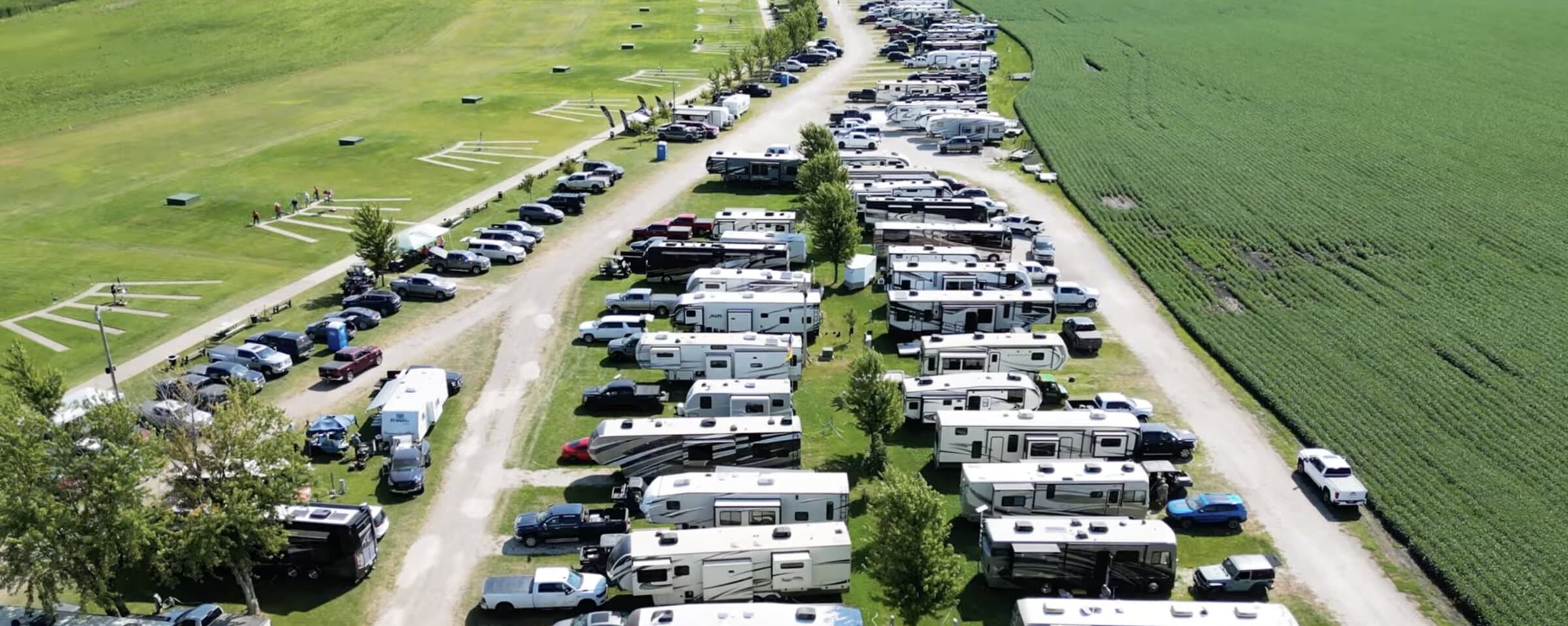 Aerial view of RVs and trailers parked along the Stockdale Gun Club camping rows during the Heartland Grand