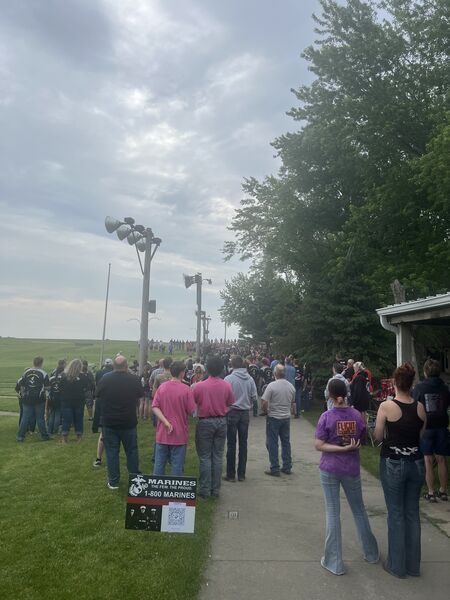 The gallery lined up along the clubhouse to watch the squads.